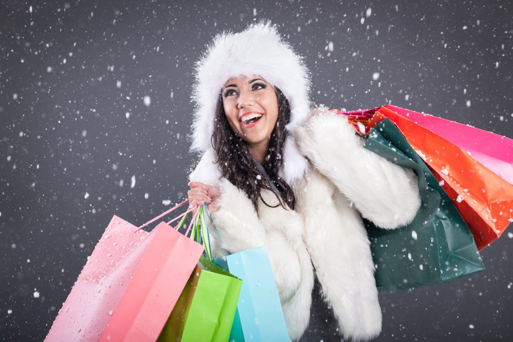 happy woman shopping at fur coat sale
